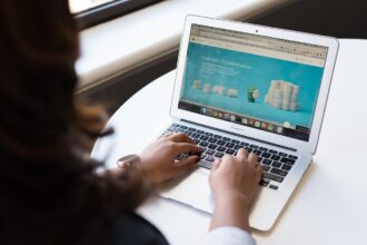 Woman sitting near a desk while using a MacBook